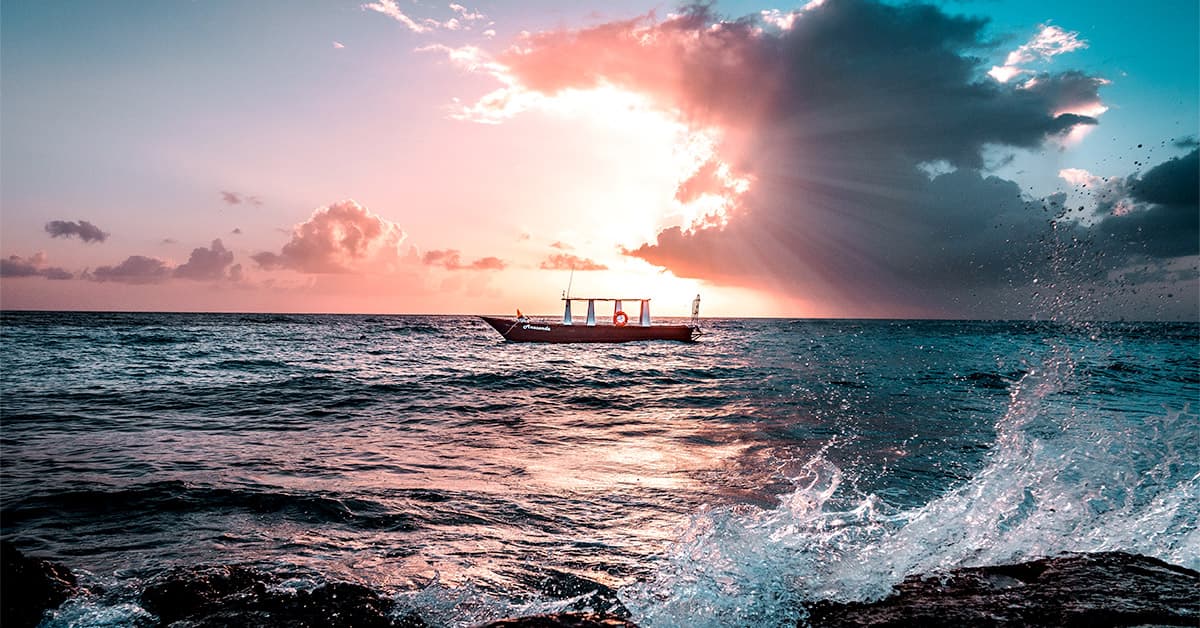 Boat on sea at sunset